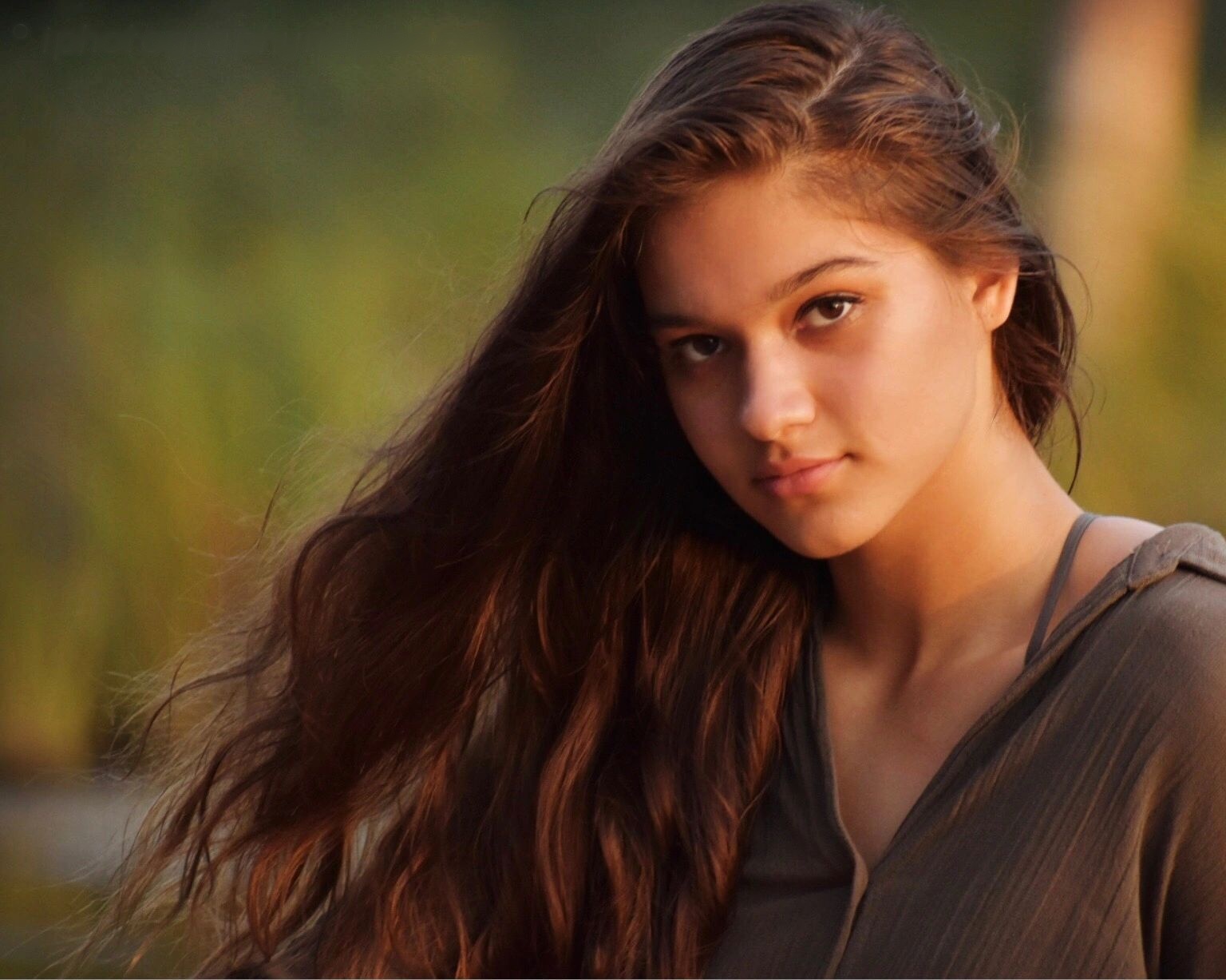 Woman with long dark hair in warm natural light