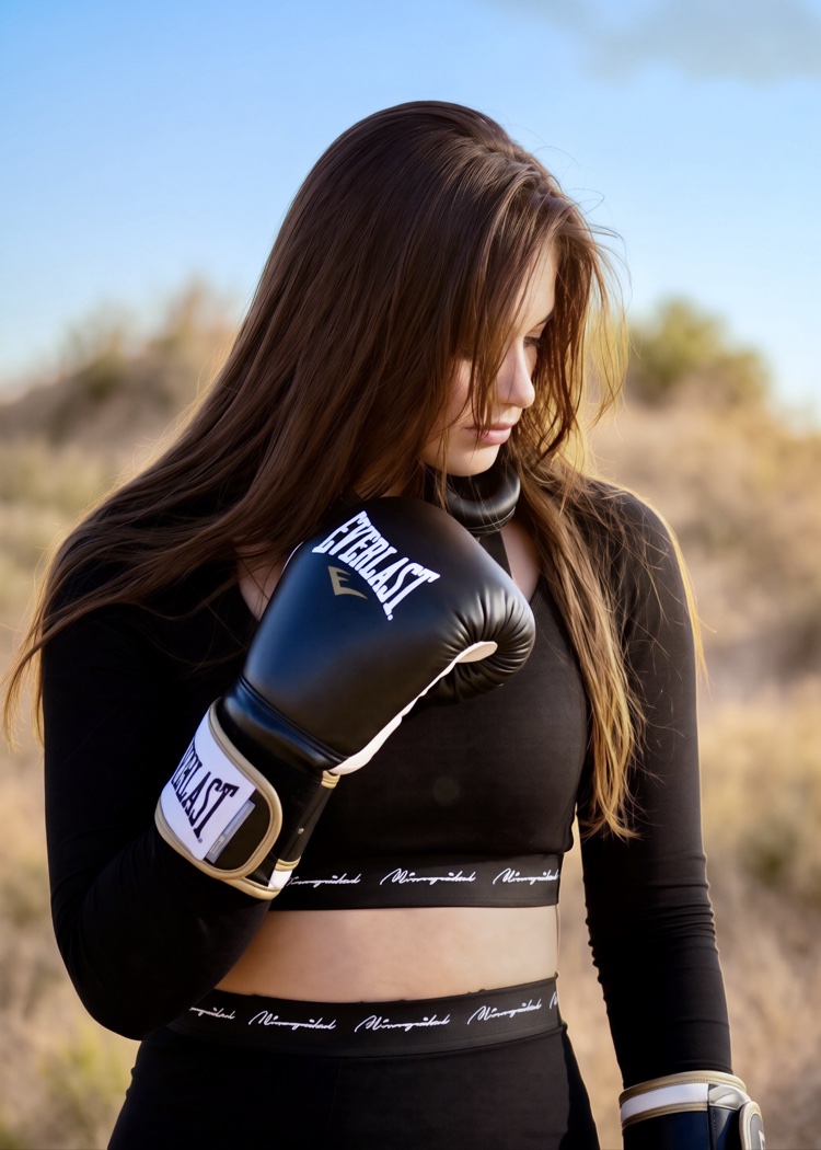 Boxer portrait with bowed head and black Everlast gloves